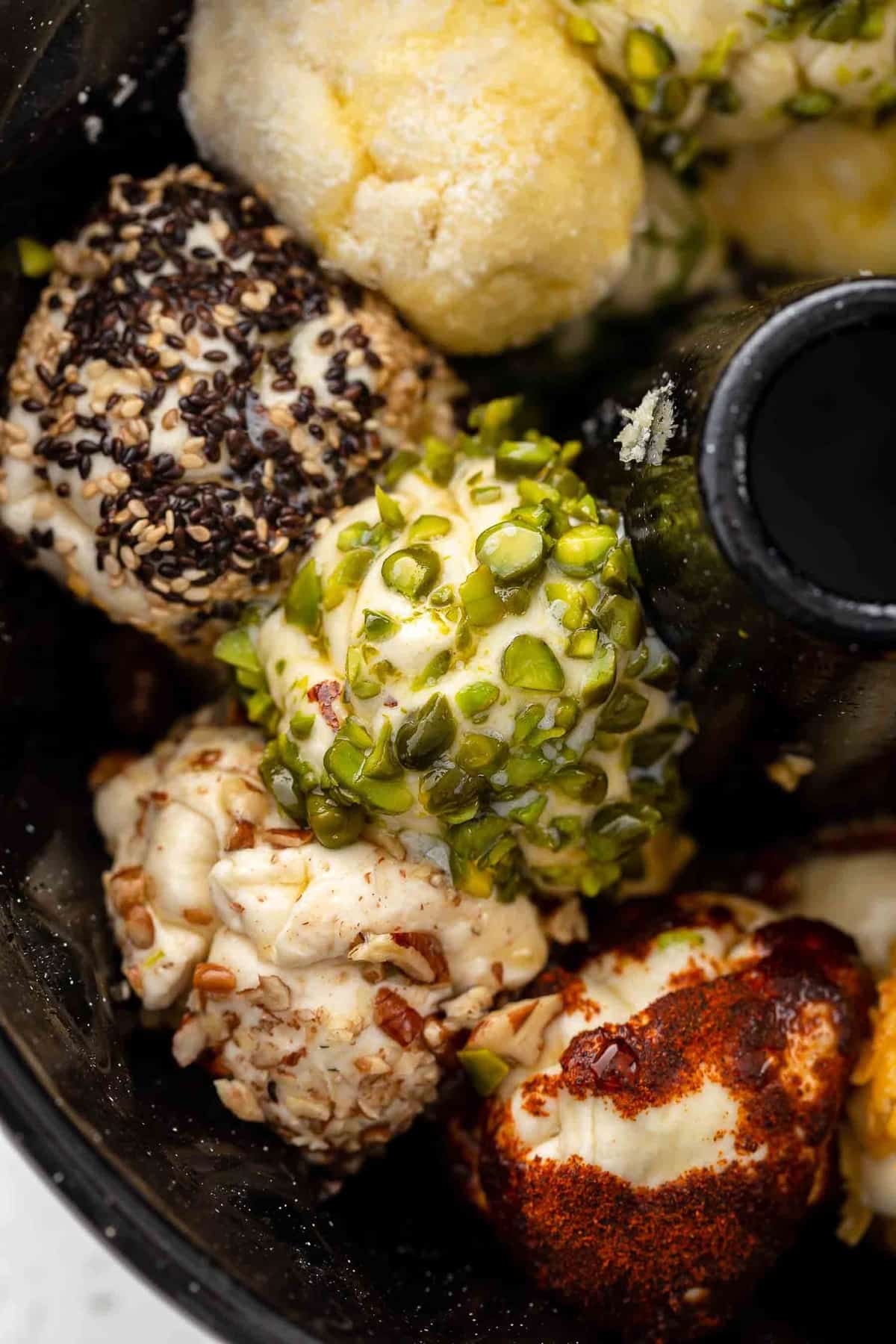 close up on bread dough covered in savory ingredients