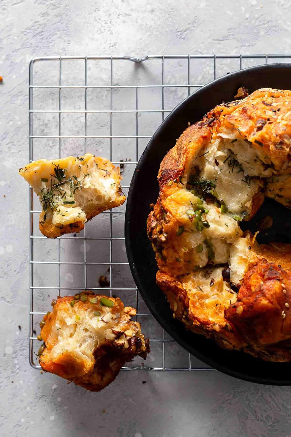 savory bread in a pan, sitting on a cooling rack