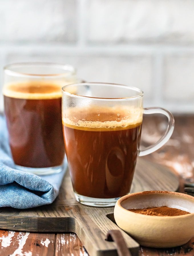 two transparent coffee mugs filled with vanila keto coffee