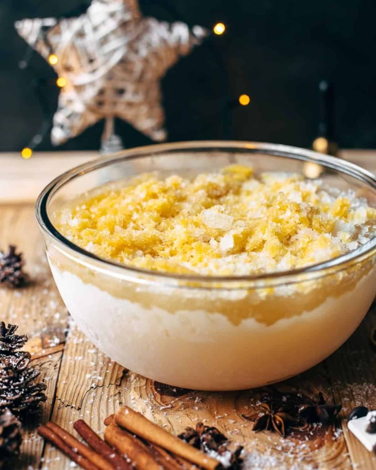 This Bourbon Slush cocktail drink is loved by all who come to my house on Christmas Eve. We have this Orange Bourbon Slush every year and it's such a fun and easy drink recipe, you have no reason not to try it! Orange bourbon slushie in a glass bowl.