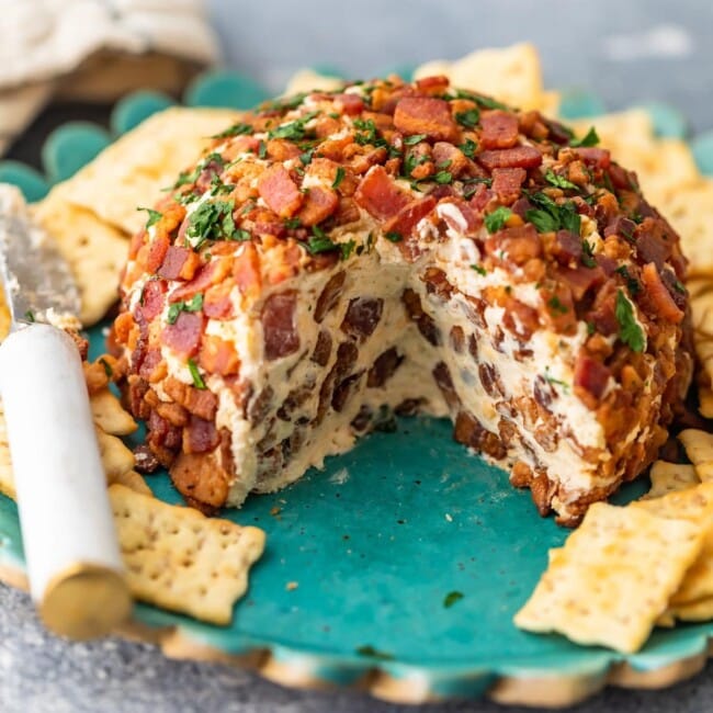 This Bacon Ranch Cheese Ball puts a delicious kick on the classic cheese ball recipe we all know and love. Cream cheese, ranch, bacon, and more are combined in this tasty bacon cheese ball recipe for lots of flavor. It's perfect as a Christmas party appetizer, New Year's Eve appetizer, or for game day!