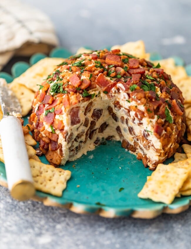 This Bacon Ranch Cheese Ball puts a delicious kick on the classic cheese ball recipe we all know and love. Cream cheese, ranch, bacon, and more are combined in this tasty bacon cheese ball recipe for lots of flavor. It's perfect as a Christmas party appetizer, New Year's Eve appetizer, or for game day!
