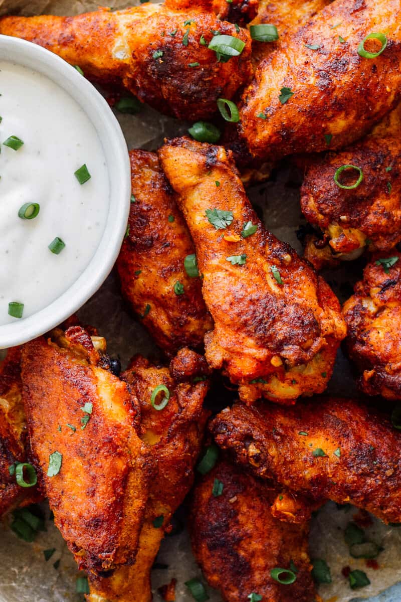 up close simple spiced baked chicken wings on platter with ranch