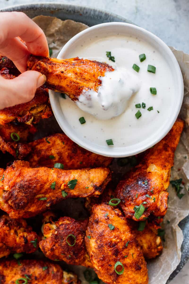 dipping baked chicken wing in ranch