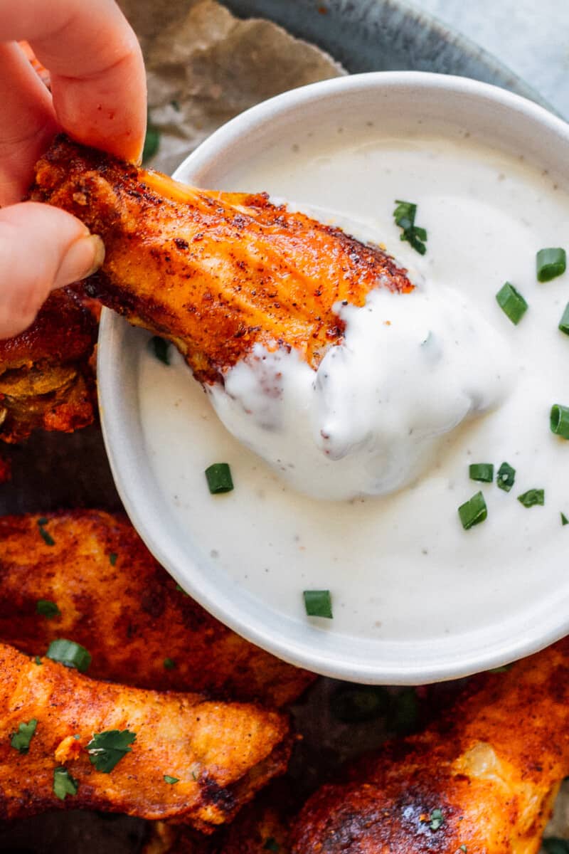 dipping baked chicken wing in ranch