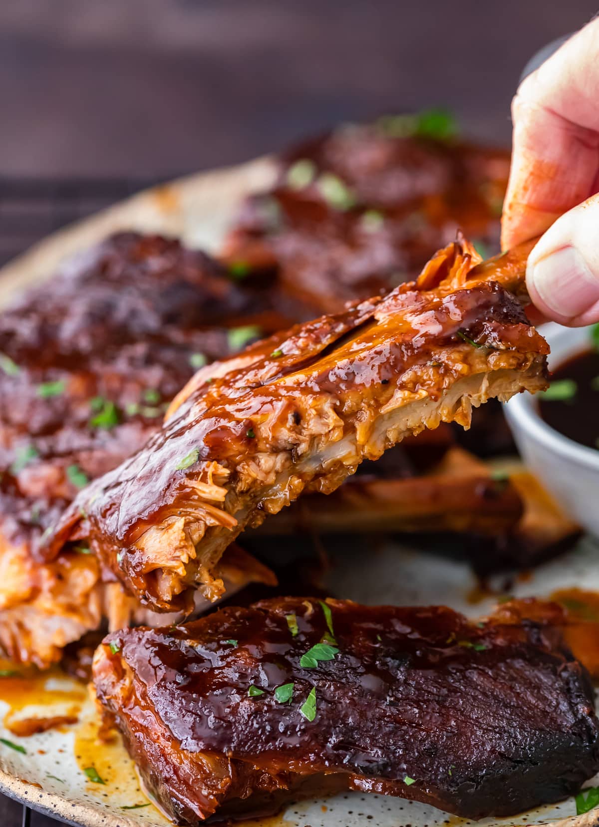 picking up BBQ ribs from a plate