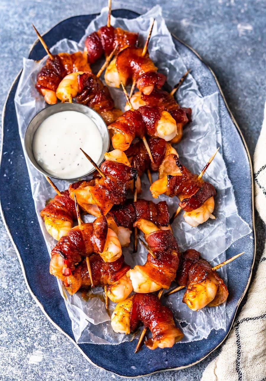 a serving plate filled with bacon wrapped shrimp