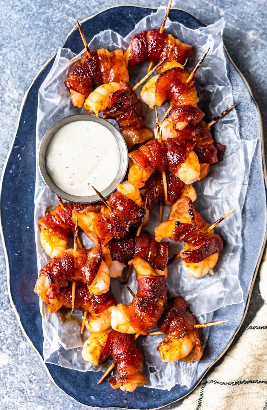 bacon wrapped shrimp appetizers on a serving plate