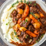 Beef Bourguignon is a delicious beef stew that's perfect for winter meals. Also known as beef burgundy or boeuf bourguignon, this dish is hearty and filling. This beef bourguignon recipe is made with beef, red wine, beef broth, and lots of vegetables. Serve this beef burgundy stew with mashed potatoes, egg noodles, rice, or all on its own. It's delicious no matter what!