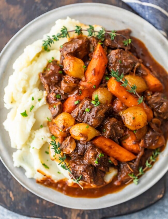 Beef Bourguignon is a delicious beef stew that's perfect for winter meals. Also known as beef burgundy or boeuf bourguignon, this dish is hearty and filling. This beef bourguignon recipe is made with beef, red wine, beef broth, and lots of vegetables. Serve this beef burgundy stew with mashed potatoes, egg noodles, rice, or all on its own. It's delicious no matter what!