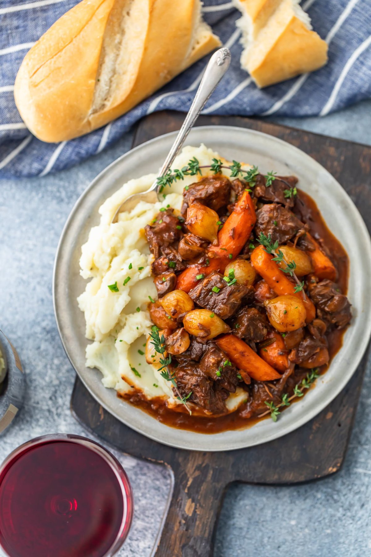 a plate of beef burgundy stew with mashed potatoes