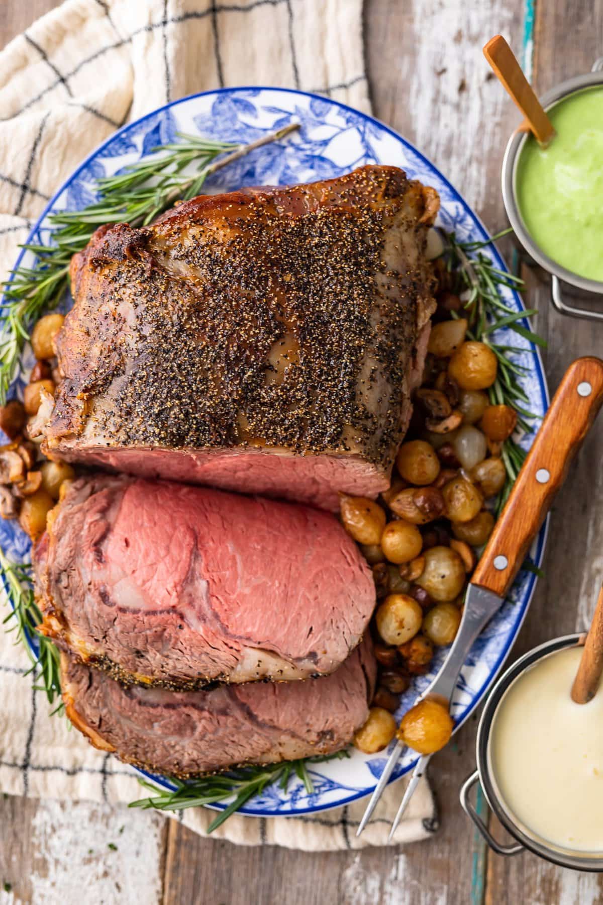 prime rib roast and potatoes on a serving platter