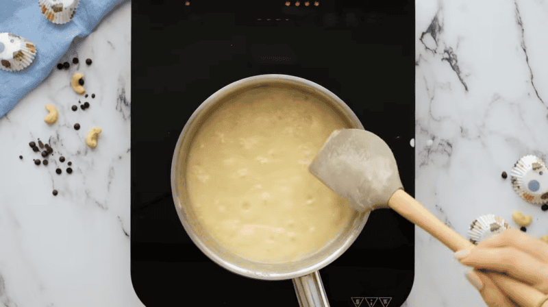 boiled sweetened evaporated milk in a saucepan with a rubber spatula.