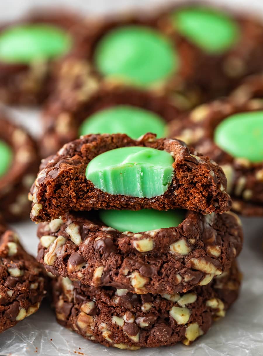 three thumbprint cookies stacked on top of each other, with a bite taken out of the top one