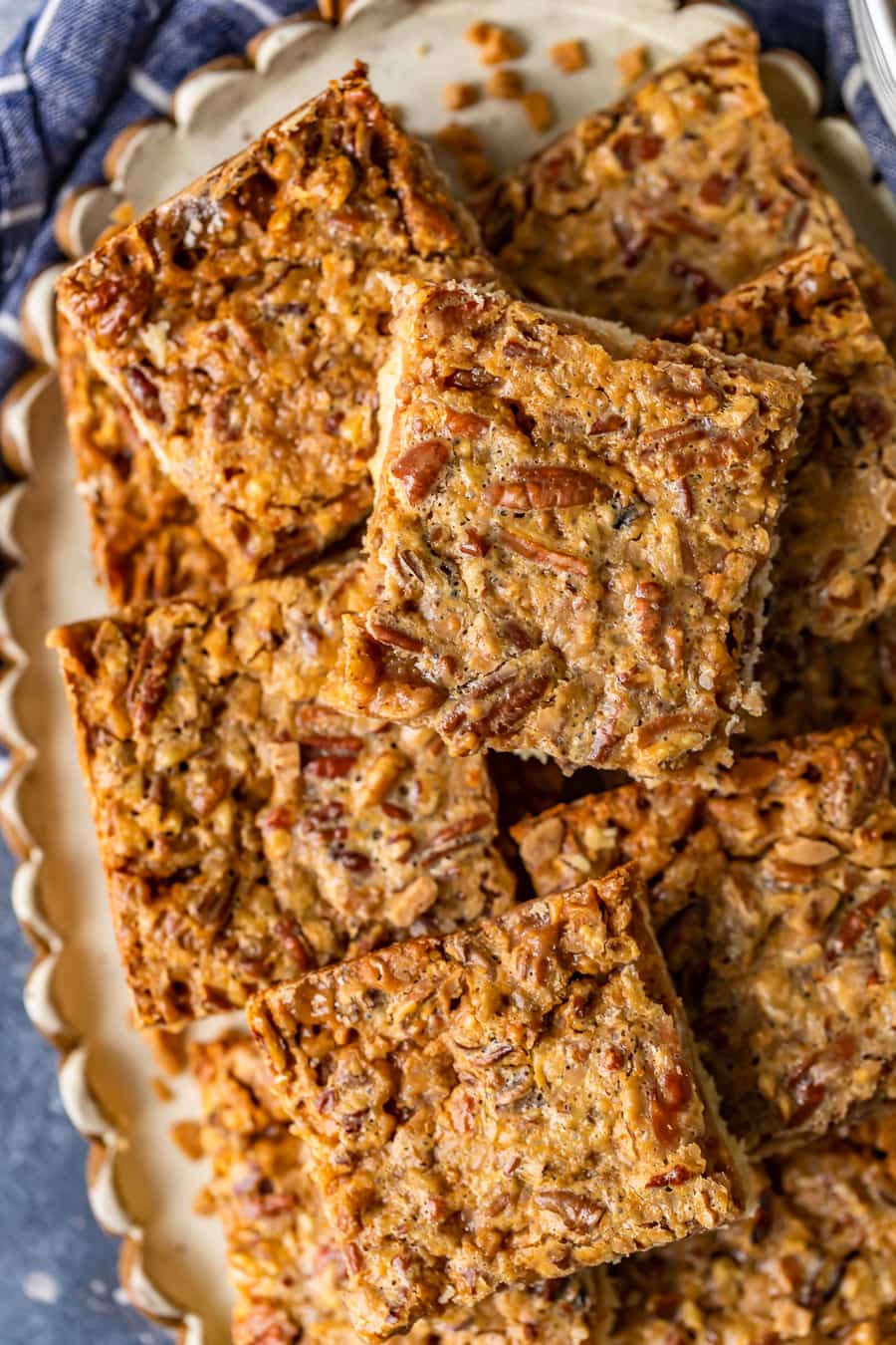 overhead view of pecan pie bars stacked up on a serving plate