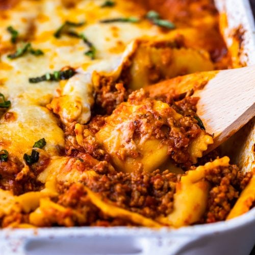 Ravioli Lasagna is a delicious mix of two favorite pasta dishes. This cheesy ravioli casserole is made with layers of ravioli, marinara sauce mixed with Italian sausage, and plenty of cheese. It's an easy lasagna recipe with an extra kick! Everyone will love this ravioli lasagna bake.