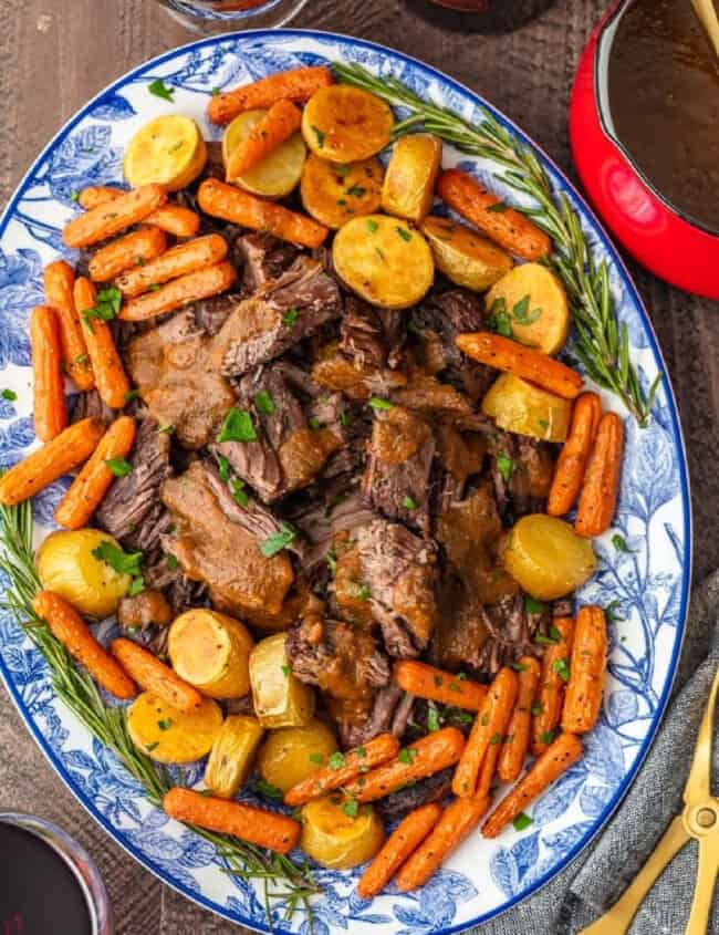 A plate of Christmas pot roast with carrots and gravy.