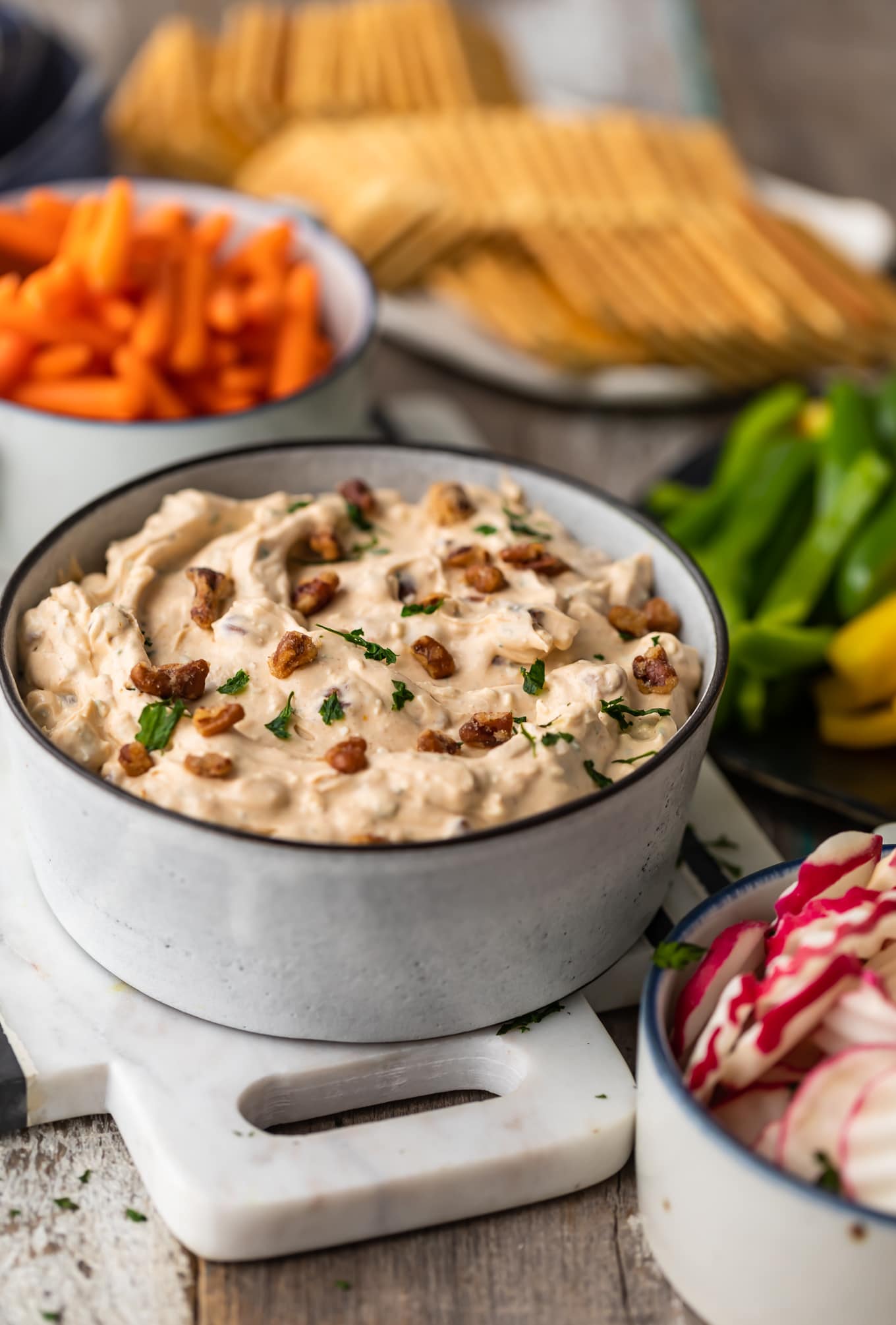 bowls of veggies, crackers, and veggie dip