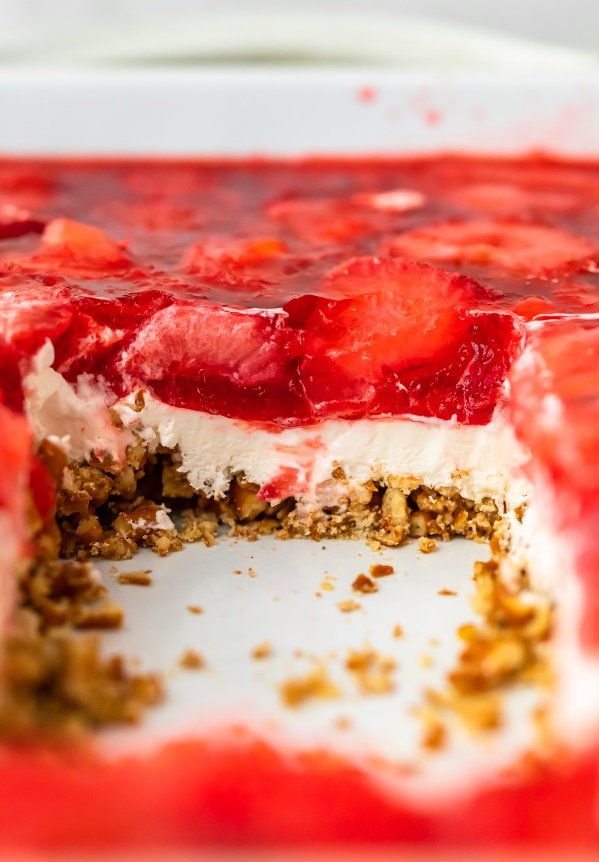 Strawberry Pretzel Salad in a baking dish with a piece cut out