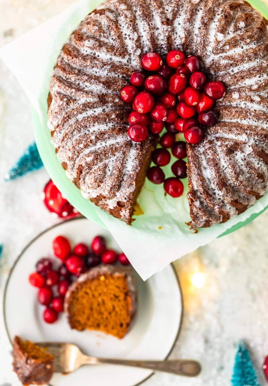 overhead view of a gingerbread bundt cake topped with cranberries
