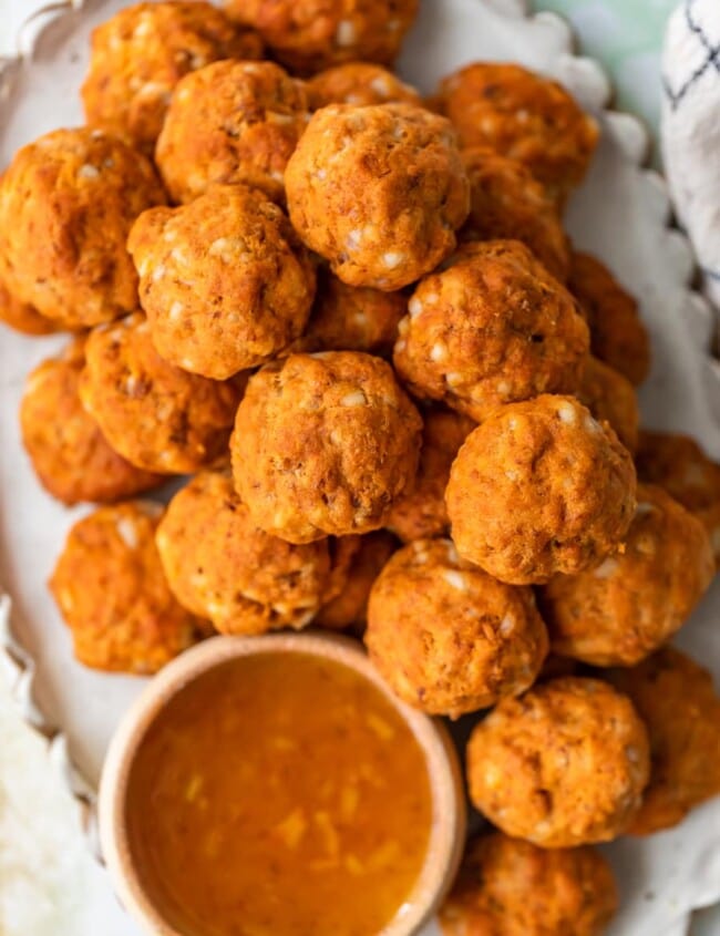 This Sausage Cheese Balls recipe puts a sweet and spicy twist on a classic appetizer. These easy sausage balls are made with cheese, sweet potato, and chorizo, and they taste amazing! Dip these Sweet Potato Sausage Balls in a spicy marmalade sauce for the final touch.