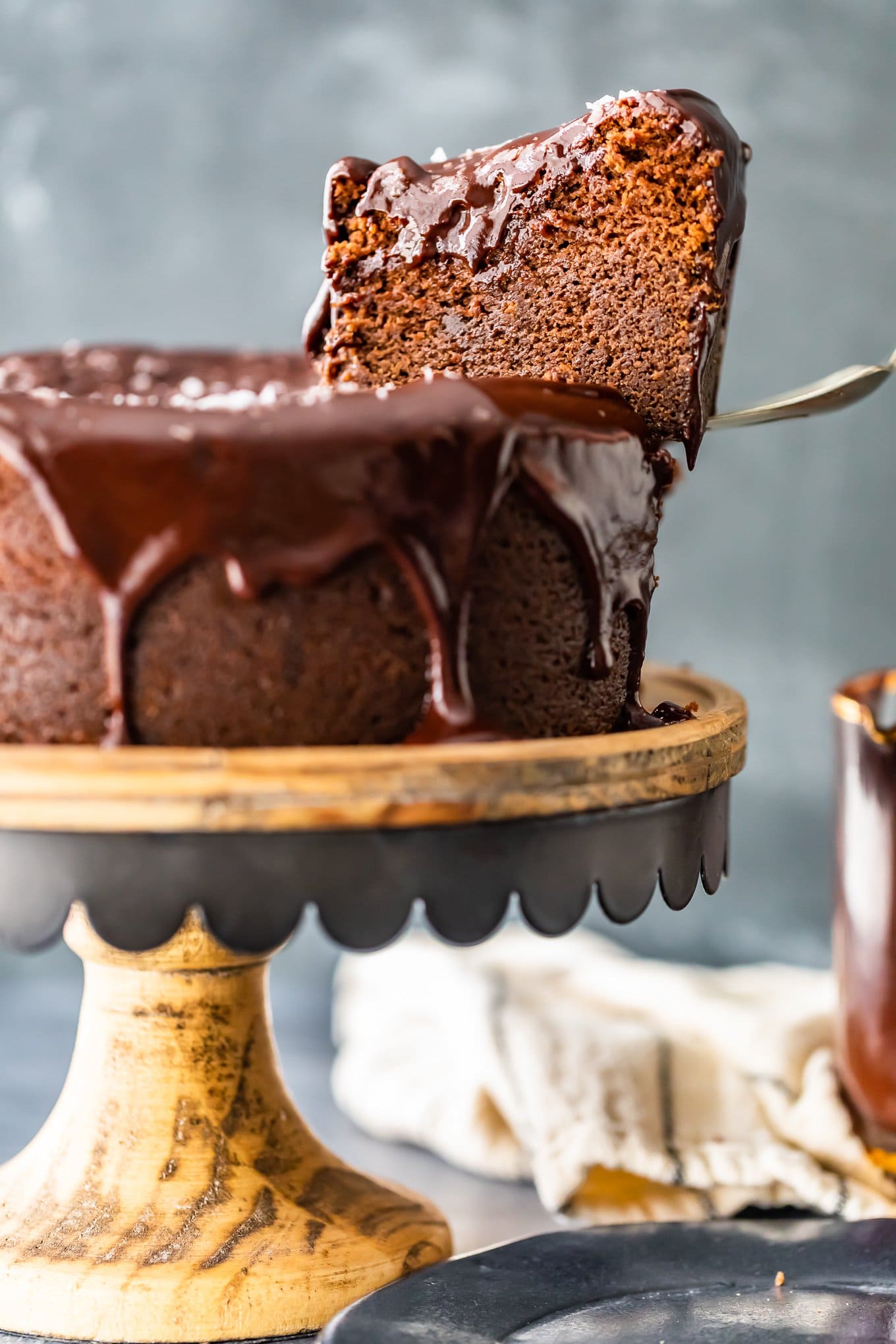 picking up a slice of cake out of a whole cake