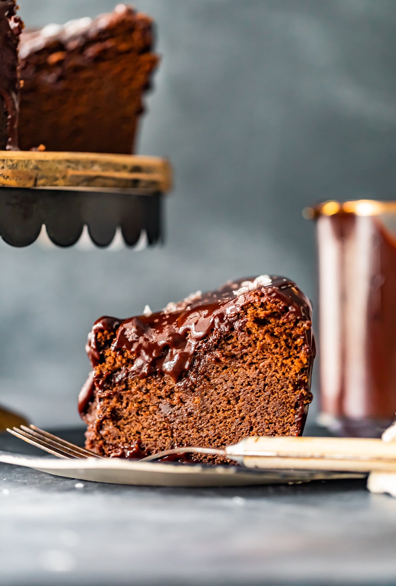 side view of a slice of chocolate cake on a plate