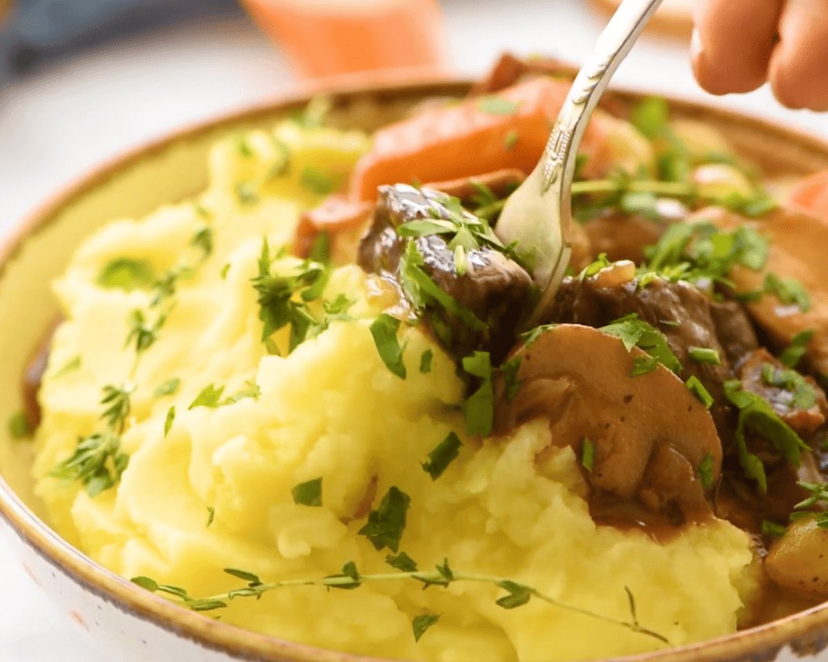 finished dish of beef burgundy served with mashed potatoes