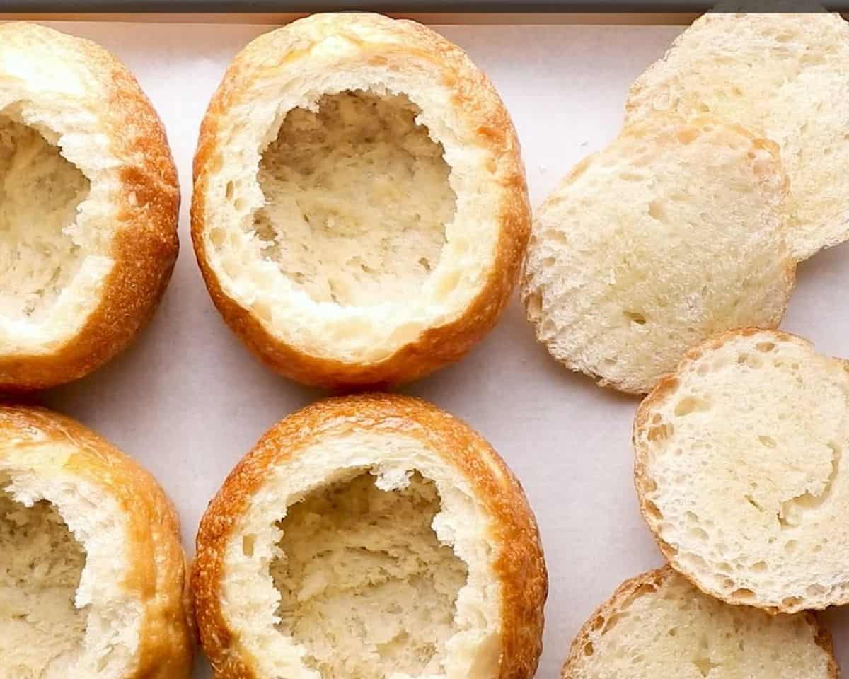 Bread bowls brushed with olive oil.