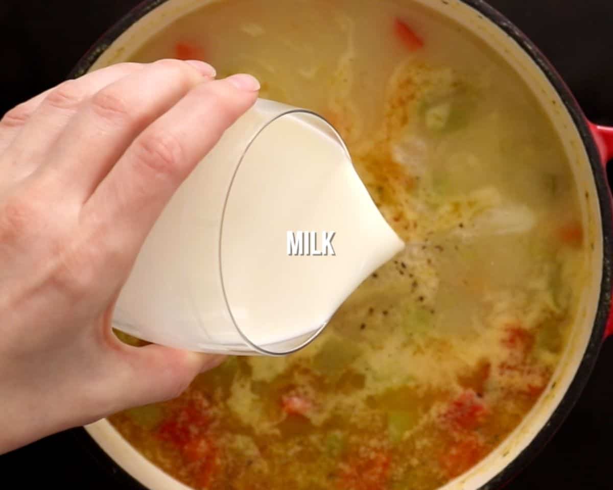 milk being added to cheesy potato soup