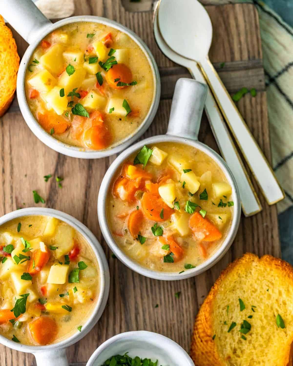 Bowls of cheesy potato soup with a slice of bread.
