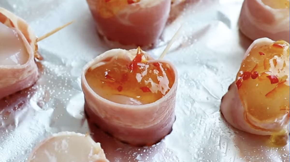 bacon wrapped scallops topped with pepper jelly.