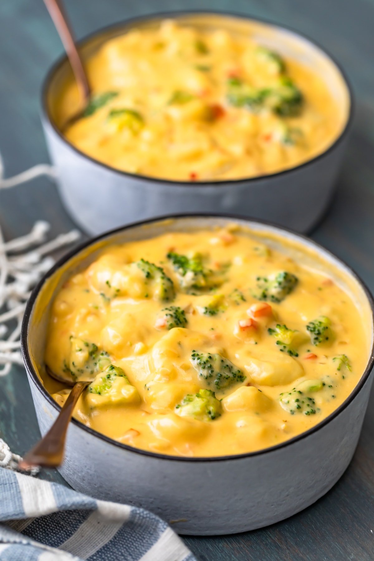two bowls of broccoli and cheese soup with gnocchi