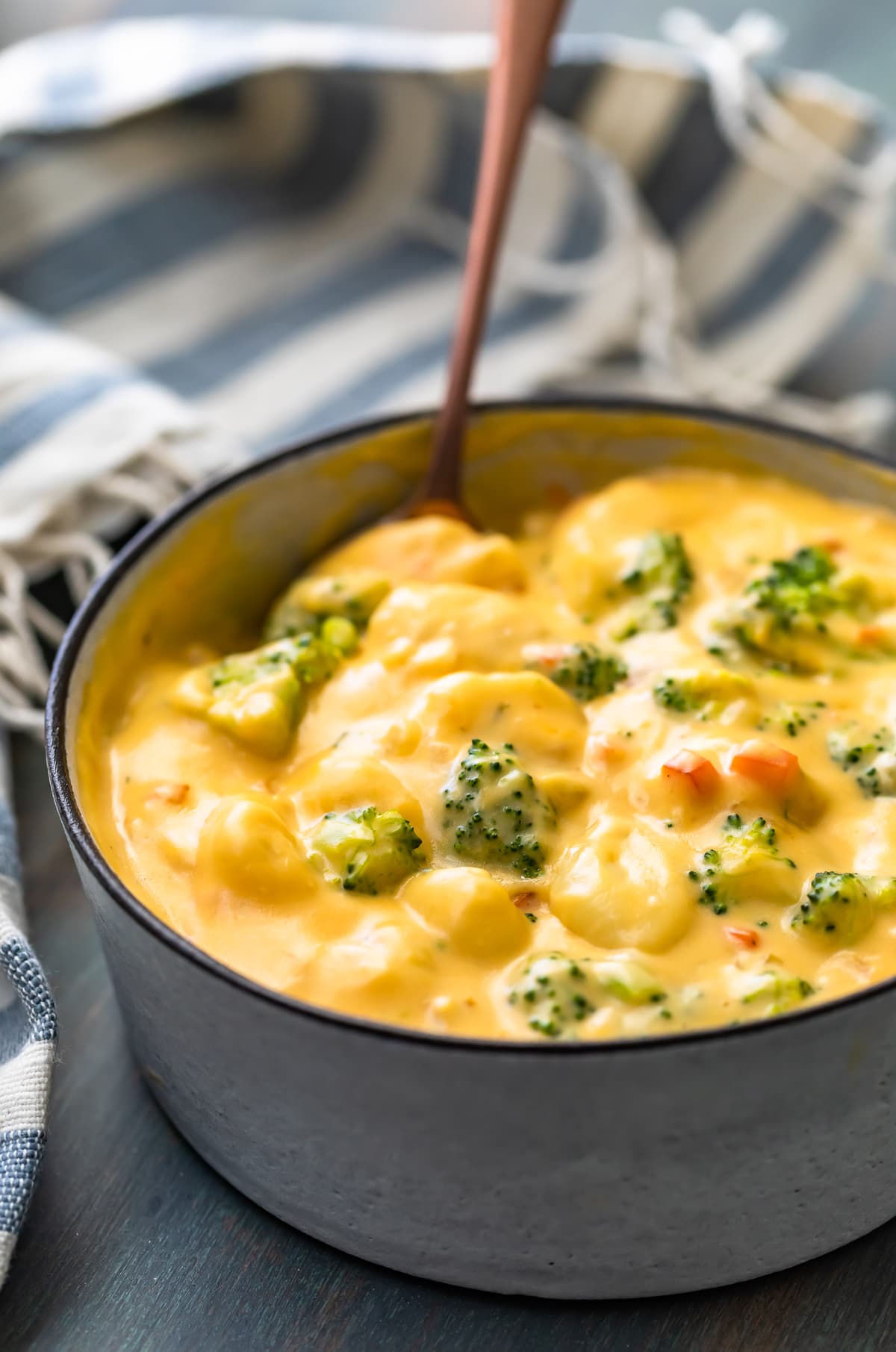 close up on a bowl of cheesy broccoli gnocchi soup