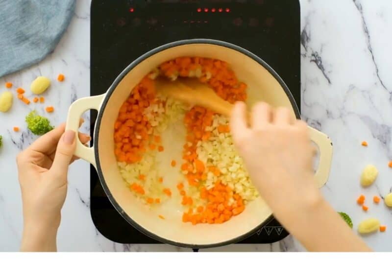 cooking chopped vegetables in butter-oil mix.