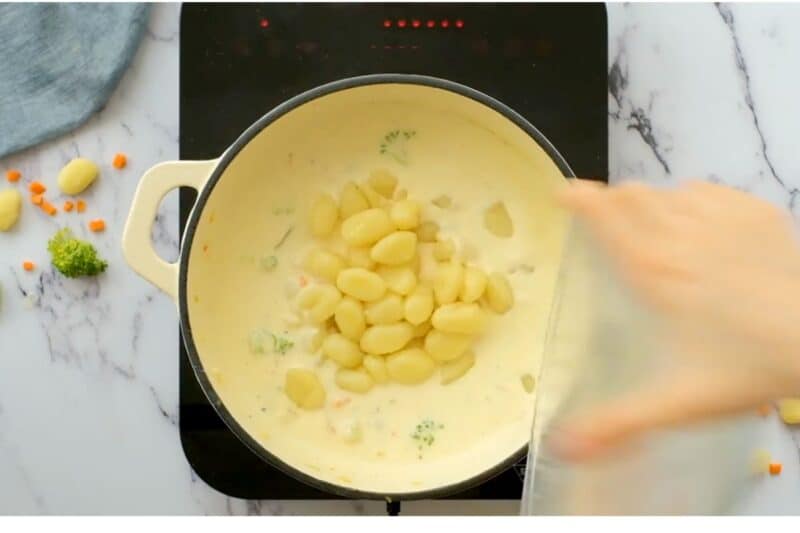 adding cooked gnocchi and stirring