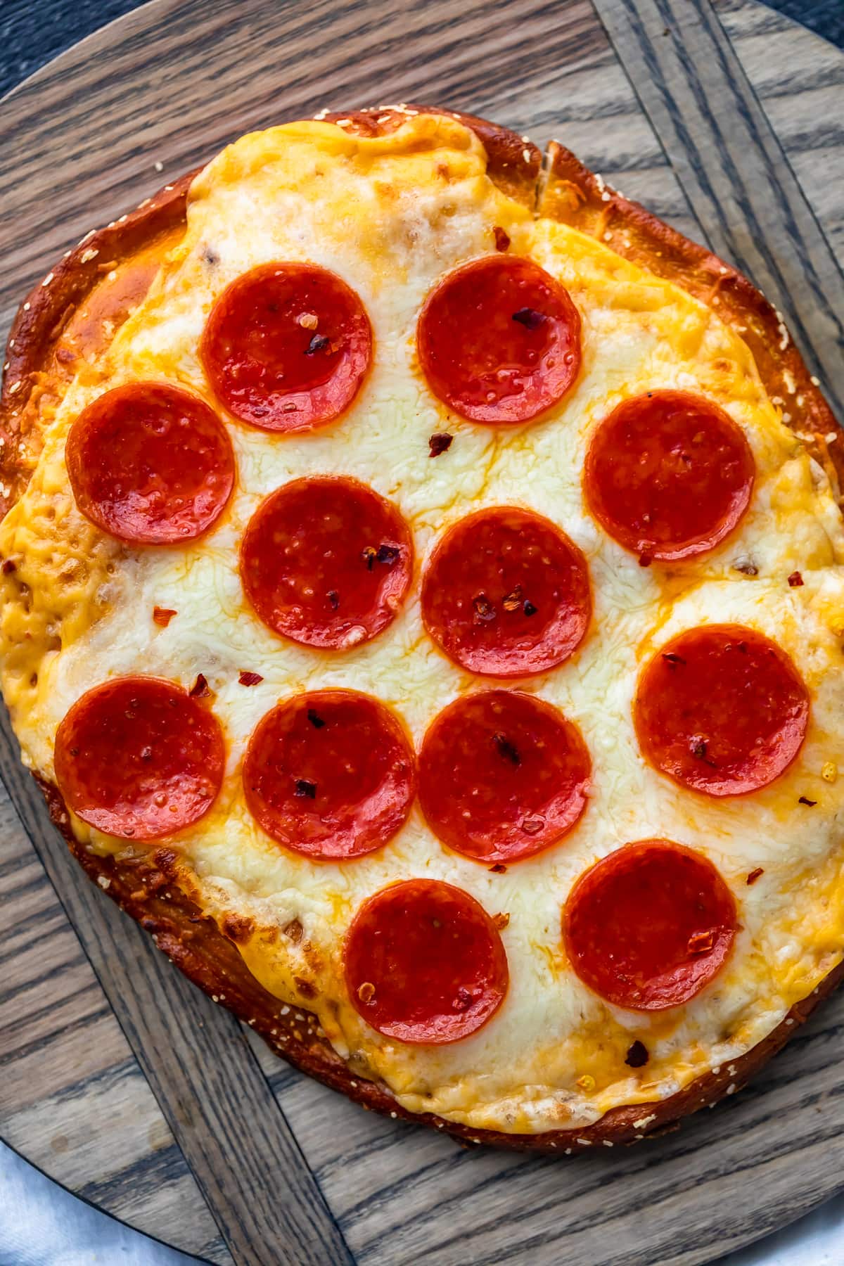 soft pretzel crust with cheese sauce and pepperonis