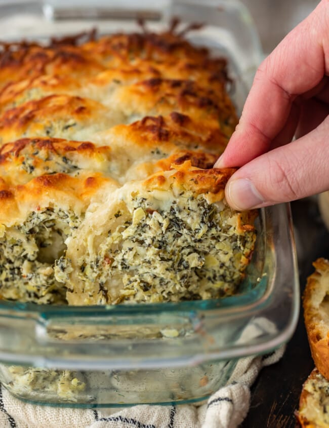Spinach Artichoke Dip Pull Apart Bread is the perfect way to get that delicious spinach artichoke flavor in the form of an easy bread. Make it as an appetizer or a tasty side dish to serve with your favorite dinners. This pull apart bread recipe is super simple and super flavorful!