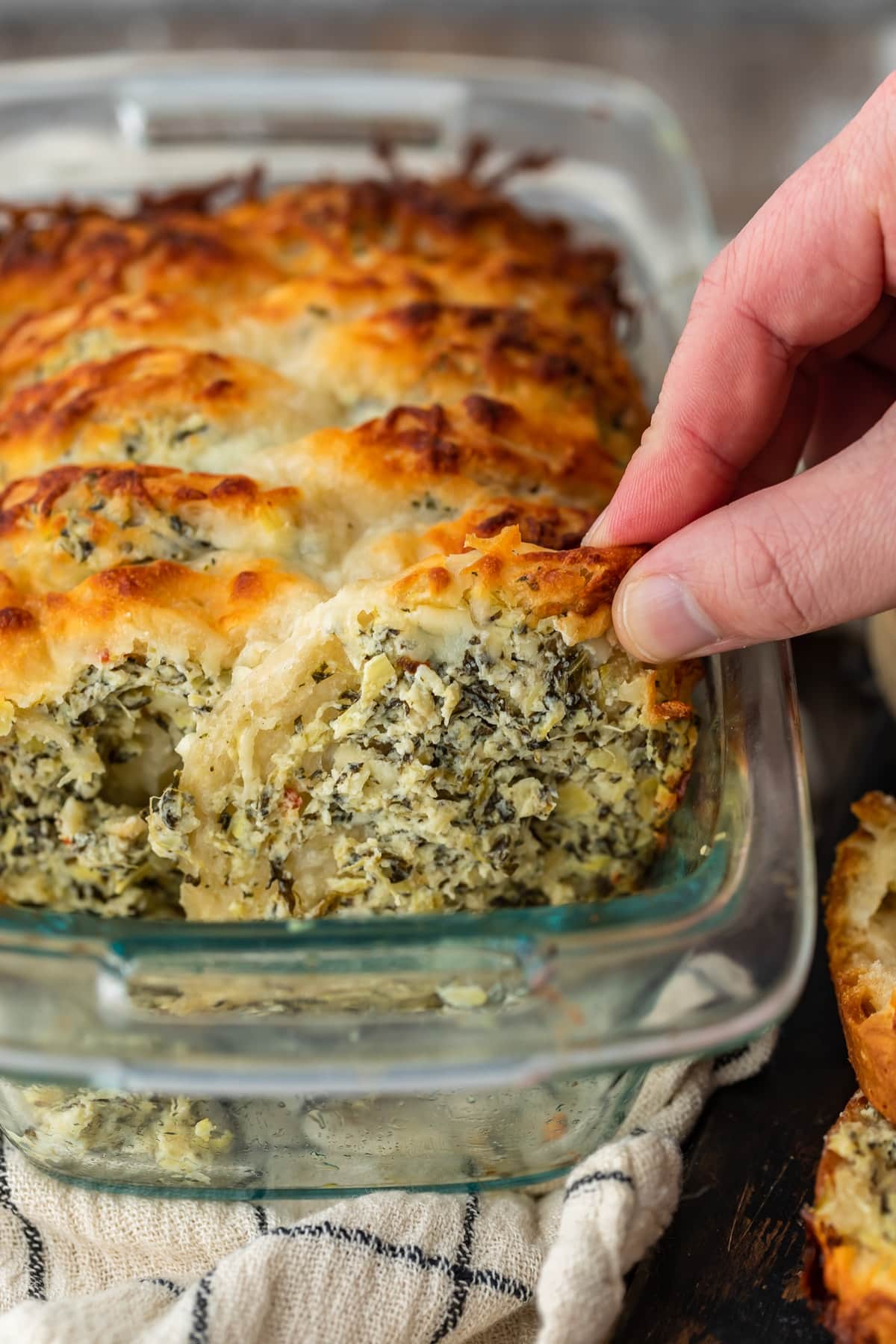spinach artichoke dip pull apart bread in a glass loaf pan