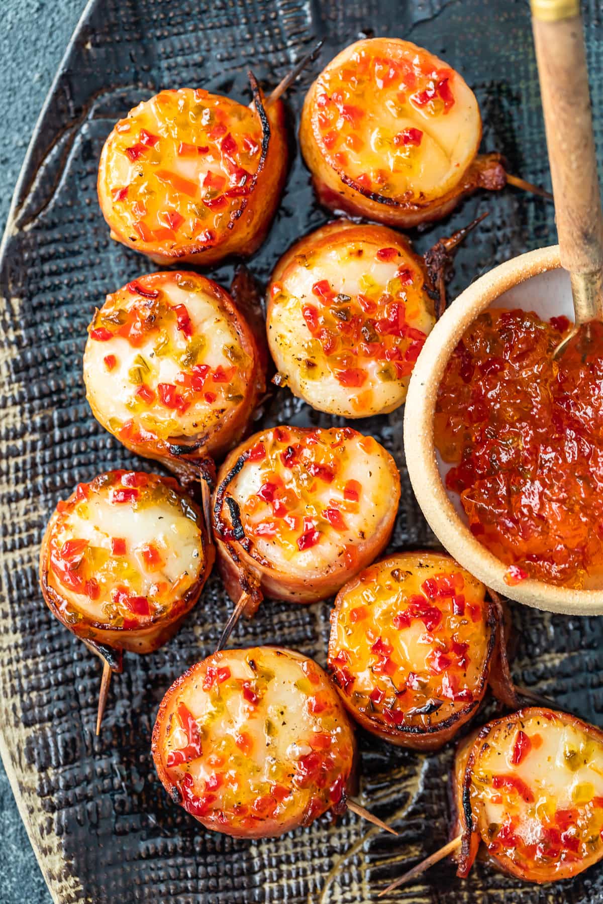 bacon wrapped scallops on a serving plate