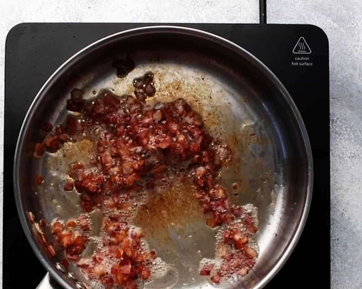 Cooking bacon in a skillet.