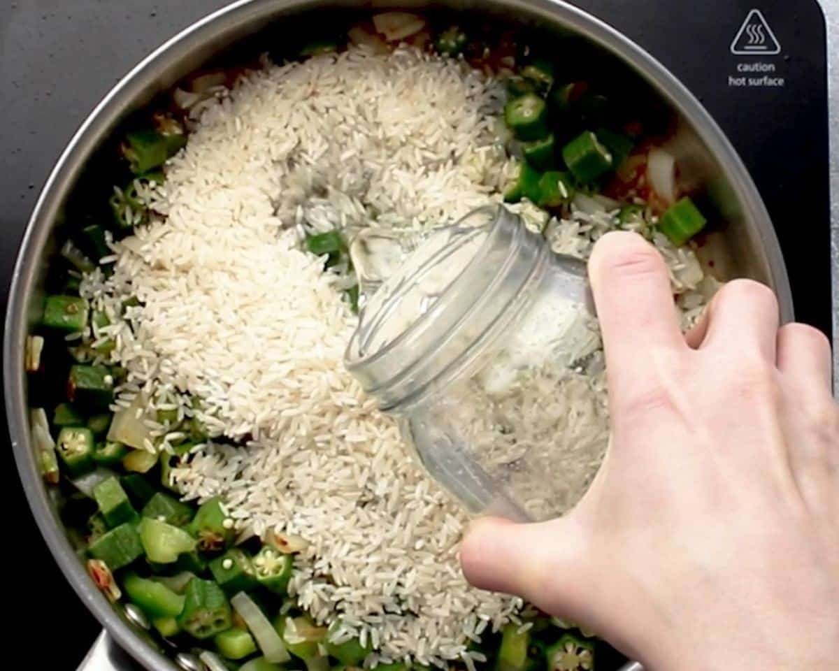 Adding rice and water to the pot.