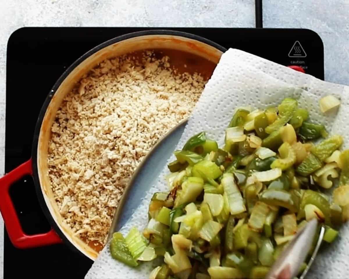 Crumbled chicken in the pot, adding green pepper and onion.