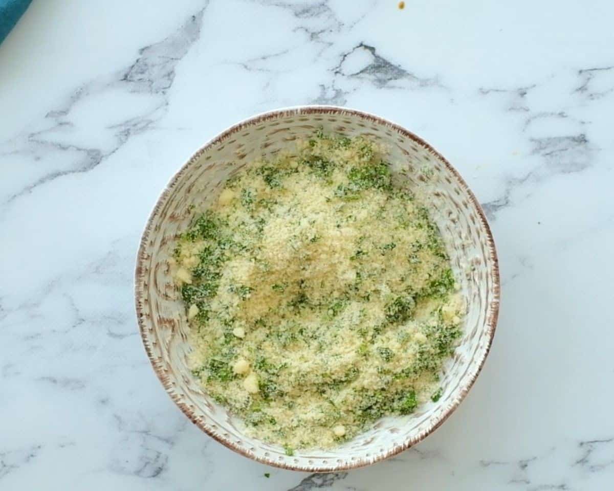 Panko bread crumbs, Parmesan cheese, and parsley in a bowl.