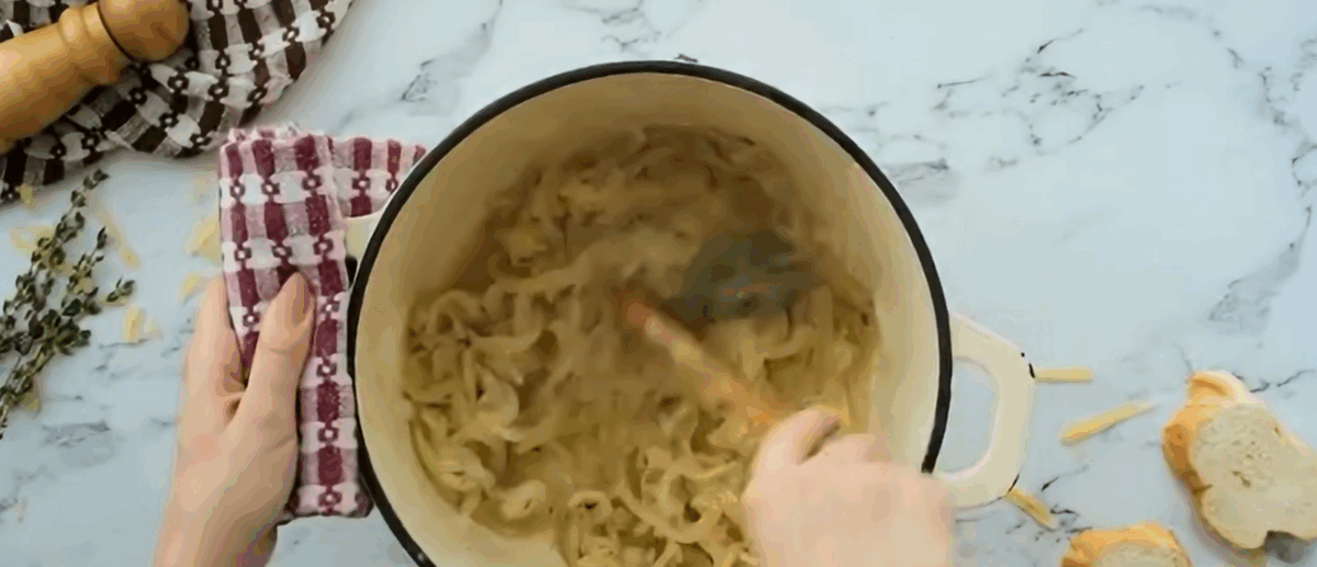 Stirring the onions in the Dutch oven. 