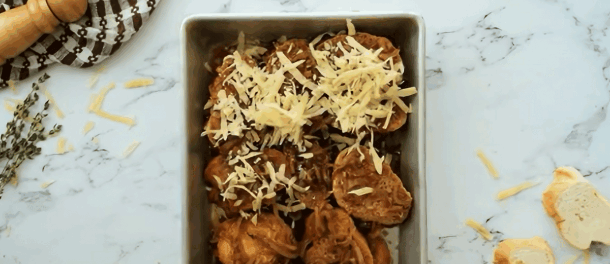 Layering the ingredients to make the casserole in a baking pan. 