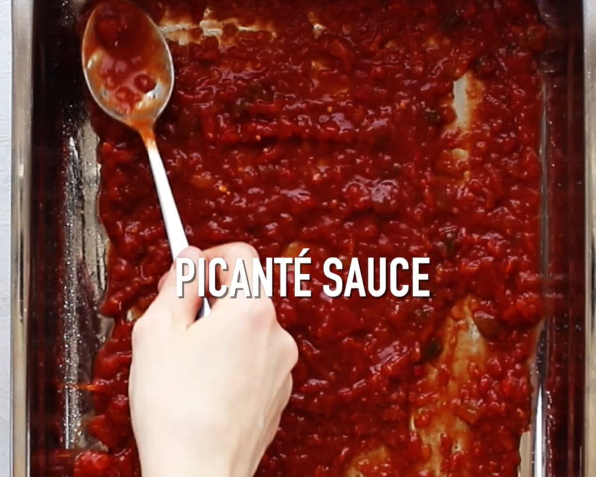 Spreading picante sauce in a pan.