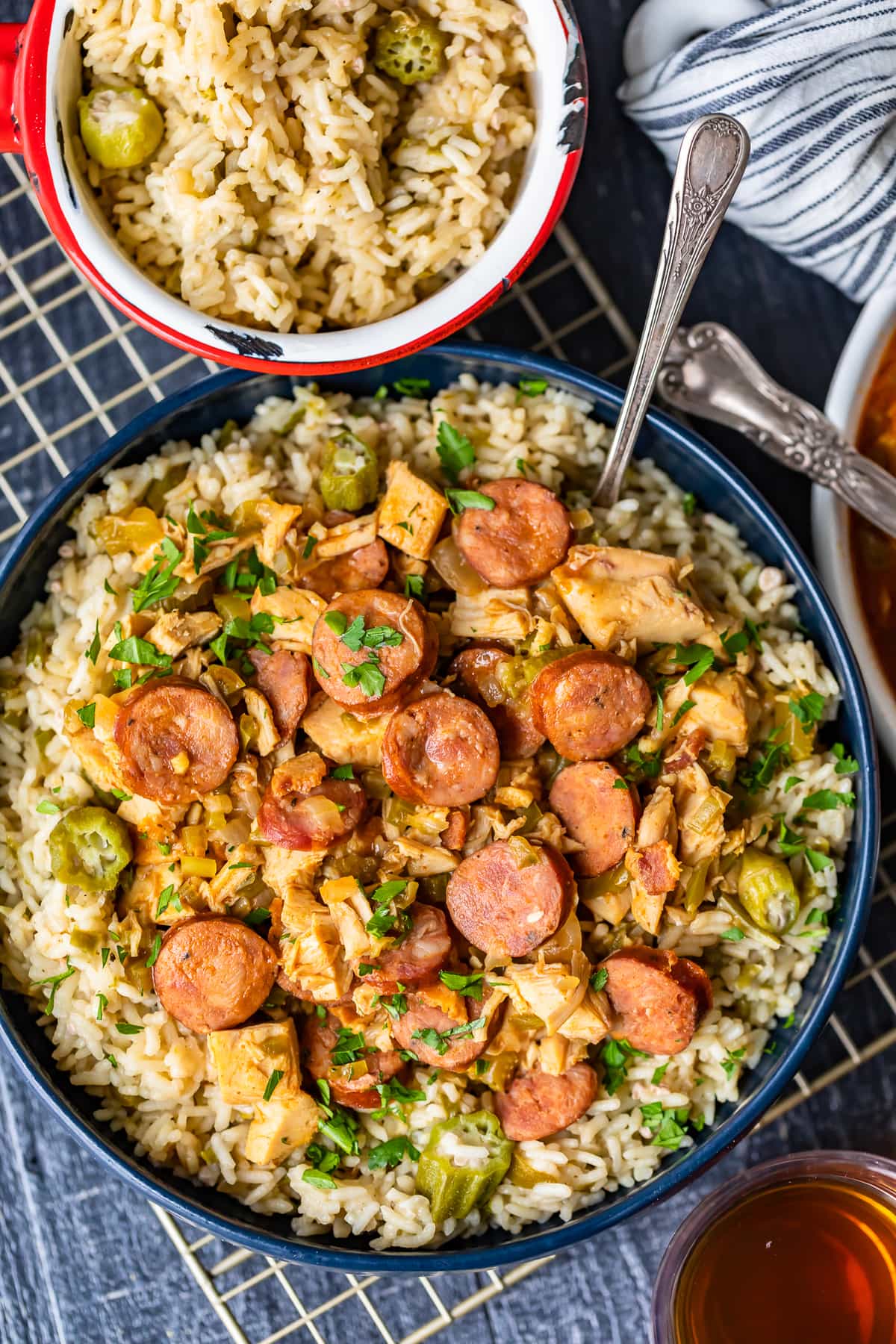 a bowl of okra rice pilaf next to a large bowl of sausage chicken gumbo