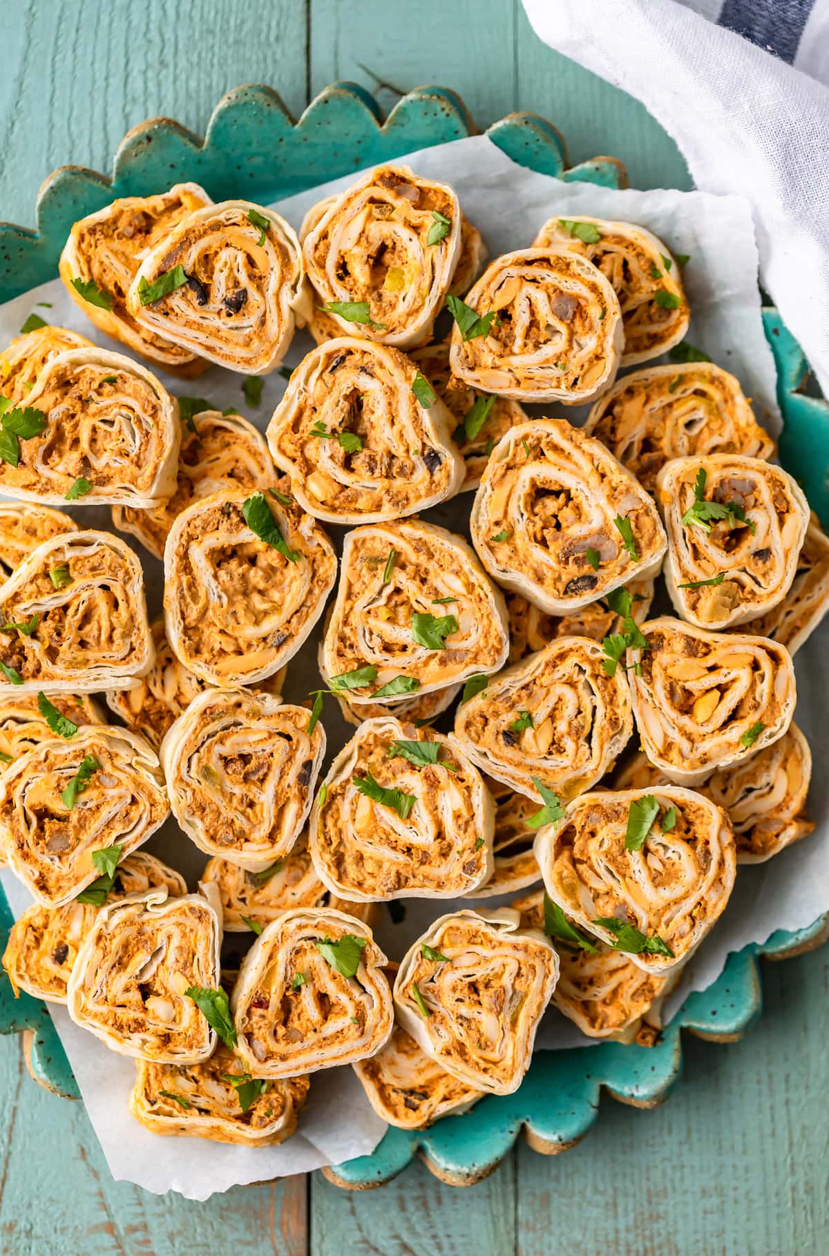 mexican roll ups arranged on a turquoise plate