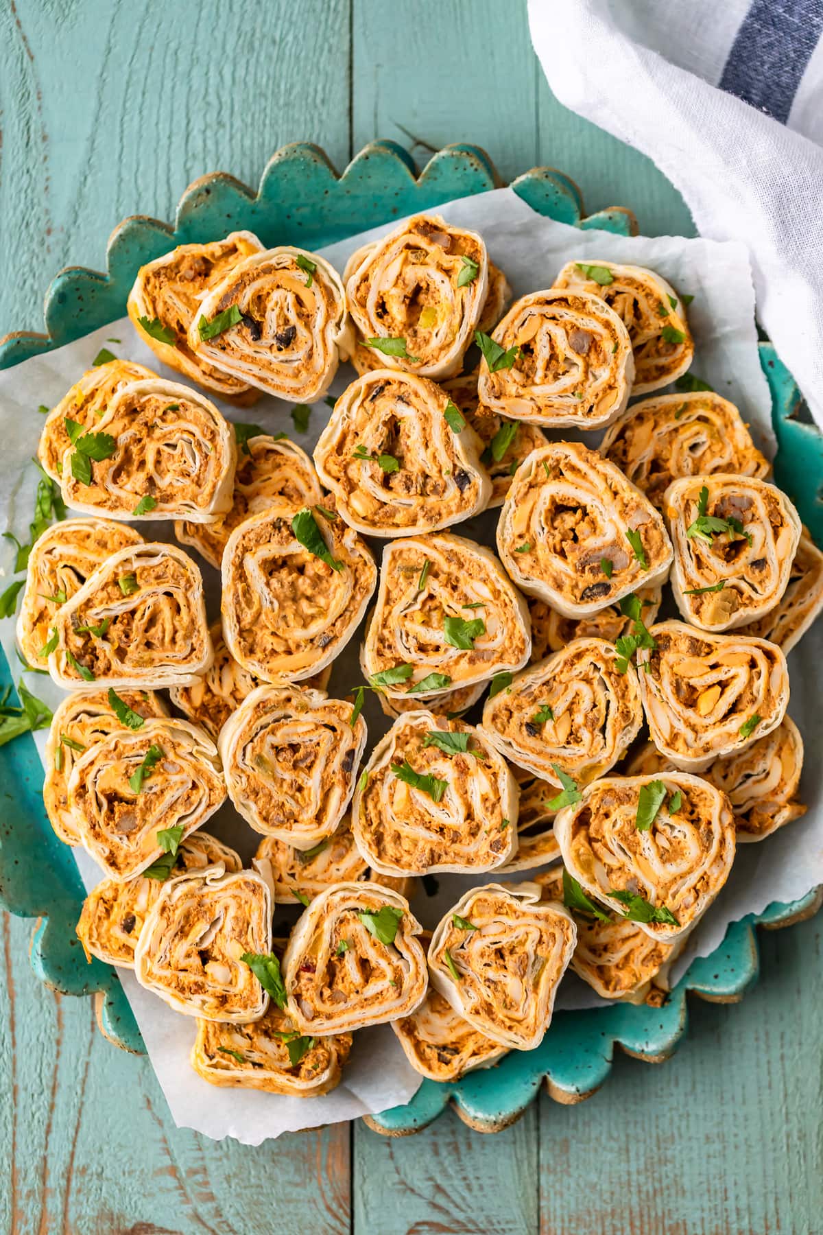 southwest sausage pinwheels on a turquoise serving plate